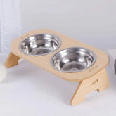 Elevated wooden pet bowl rack with 2 stainless steel bowls, tilted